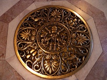 White and orange marble rings a circular, decorated bronze vent