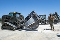 US Navy skid steer with wheel saw attachment