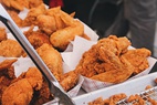 Examples of fast food (left to right, top to bottom): Cheeseburger, soft drink, french fries, pizza Margherita, hot dog, fried chicken, submarine sandwich, and donuts.