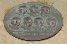 Circular plaque with the faces of the seven astronauts