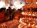 From top left to bottom right (a) Structure of a Durga sculpture-idol being made at Kumortuli; (b) Lady carrying offerings for the puja; (c) Sandhi puja on the day of Ashtami; (d) Immersion of the sculpture-idol on Vijaya Dashami.