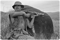 A U.S. soldier in Vietnam wearing various amulets, including the "peace symbol" and the Buddhist swastika (1971 photograph).