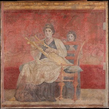 A mosaic from Thmuis (Mendes), Egypt, created by the Hellenistic artist Sophilos (signature) in about 200 BCE, now in the Greco-Roman Museum in Alexandria, Egypt; the woman depicted is probably Berenice II. Her crown showing a ship's prow and her anchor-shaped brooch symbolised the Ptolemaic Empire's naval prowess.[16]