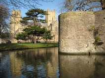 From the Market Place, Penniless Porch (left) leads to Cathedral Green, and The Bishop's Eye (right) to the Bishop's Palace.