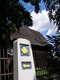 A Camino milestone by St Leonard's church, Wojnicz, Poland