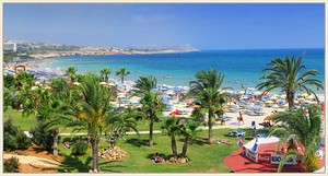 A beach in Ayia Napa seen from a hotel room with Cape Greco in the distance