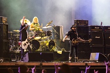 Two lineups of Motörhead performing live in 1982 (top) and 2013 (bottom).