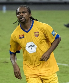 A footballer wearing an orange kit.