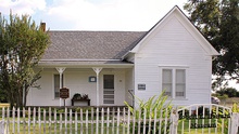 White painted house with garden