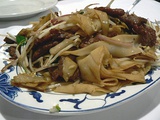 Beef chow fun (乾炒牛河) is a staple in Cantonese cuisine.