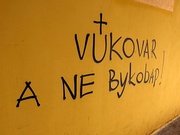 Left: Bilingual street sign in Croatian and Serbian in DaljRight: Graffiti during anti-Cyrillic protests