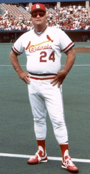 Stan Musial wearing the Cardinals' 1950s road uniform with the original navy cap and red bill.