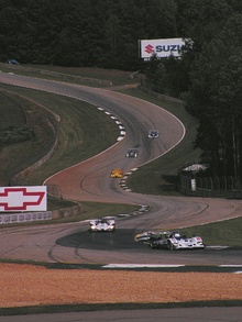 race cars driving through a series of alternating right and left corners