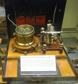 One of Marconi's first coherer receivers, used in his "black box" demonstration at Toynbee Hall, London, 1896. The coherer is at right, with the "tapper" just behind it, The relay is at left, batteries are in background