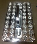 Sacrament trays containing bread and water. The bread is broken and the trays are blessed and passed to the congregation.