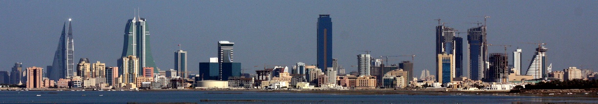  A panoramic view of the skyline of Manama from left to right:1. The twin towers of the Bahrain WTC.2. The twin towers of the Bahrain Financial Harbor (BFH).3. The NBB tower (short building next to BFH).4. The Almoayyed Tower (tallest in the photo, center of image).5. The Abraj Al Lulu residential project (three towers) under-construction on the far-right).