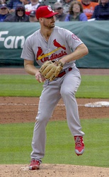 Stan Musial wearing the Cardinals' 1950s road uniform with the original navy cap and red bill.