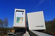 Facade and library of the Centre belge de la Bande dessinée, housed in a building which as cultural heritage is state-owned, and the entrance of the especially built Musée Hergé, both expressive of the state backing the Franco-Belgian comic receives in its native country