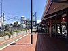 Bassendean station viewed from platform with large shelter on the platform and fare gates in the distance