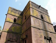 The Church of Saint George, Lalibela and a panel painting inside depicting Saint George slaying a dragon; it is one of eleven monumental rock-hewn churches built in Lalibela, Ethiopia that were allegedly sculpted after a vision by the Zagwe-dynasty ruler Gebre Mesqel Lalibela (r. 1185–1225 AD), in which St George instructed him to do so.[38] The city of Lalibela was reestablished as a symbolic new holy site, following the fall of Jerusalem to the Muslim forces of Saladin in 1187 AD, yet archaeology reveals the religious structures to have been built between the 10th and early 12th centuries AD, with perhaps only the last phase carried out during the 13th century AD and reign of Gebre Mesqel Lalibela.[39]