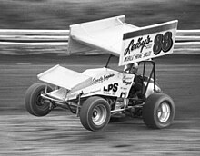 a race car with its front wheels off the ground