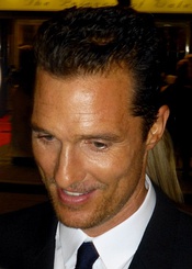 A profile picture of a middle-aged man with brown color, smiling at something.