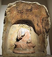 Buddha with flying Erotes holding a wreath overhead, Tapa Kalan, 3rd century CE