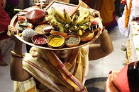 From top left to bottom right (a) Structure of a Durga sculpture-idol being made at Kumortuli; (b) Lady carrying offerings for the puja; (c) Sandhi puja on the day of Ashtami; (d) Immersion of the sculpture-idol on Vijaya Dashami.