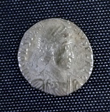 A smaller silver coin in the centre a head – still a fairly round coin but the inscription is not intact and there is no space between it and the rim