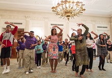 Michelle Obama dancing with a large group of people