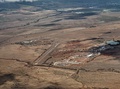 Aerial view, from the south, of Puʻunēnē with the old airstrip that is now the dragstrip at Maui Raceway Park