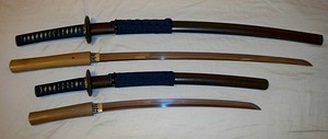 Antique Japanese (samurai) daishō, the traditional pairing of two Japanese swords which were the symbol of the samurai, showing the traditional Japanese sword cases (koshirae) and the difference in size between the katana (top) and the smaller wakizashi/kodachi (bottom).