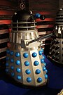 Various Dalek designs from throughout the series, including variants such as the Special Weapons Dalek and the Dalek Emperor.