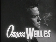 Welles surrounded by cigarette smoke