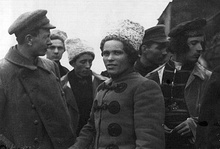 Nestor Makhno and Fedir Shchus standing together with other Makhnovists in front of a train