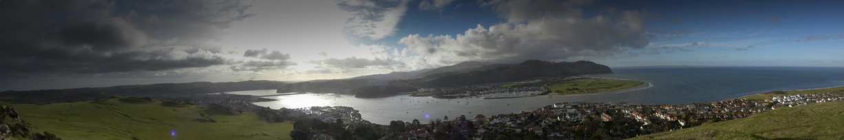  Panorama of six pictures stitched together showing the mouth of the Conwy Estuary (right) and the location of Conwy Castle (left of centre)