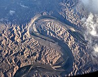 Left: Aerial view of the Green from the north, location south of Ouray, Utah. Right: Bowknot Bend on the Green River, north of Canyonlands National Park. Named by John Wesley Powell in 1869 (see quote in text).