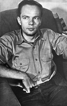 A black-and-white photo of Dick seated