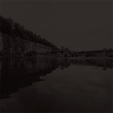 Photograph of a quarry lake at night.