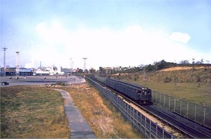 A train operating on the World's Fair railroad line in the middle of a field