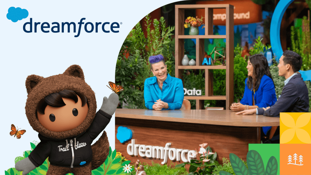 A group of people at Dreamforce event smiling and sitting at a desk