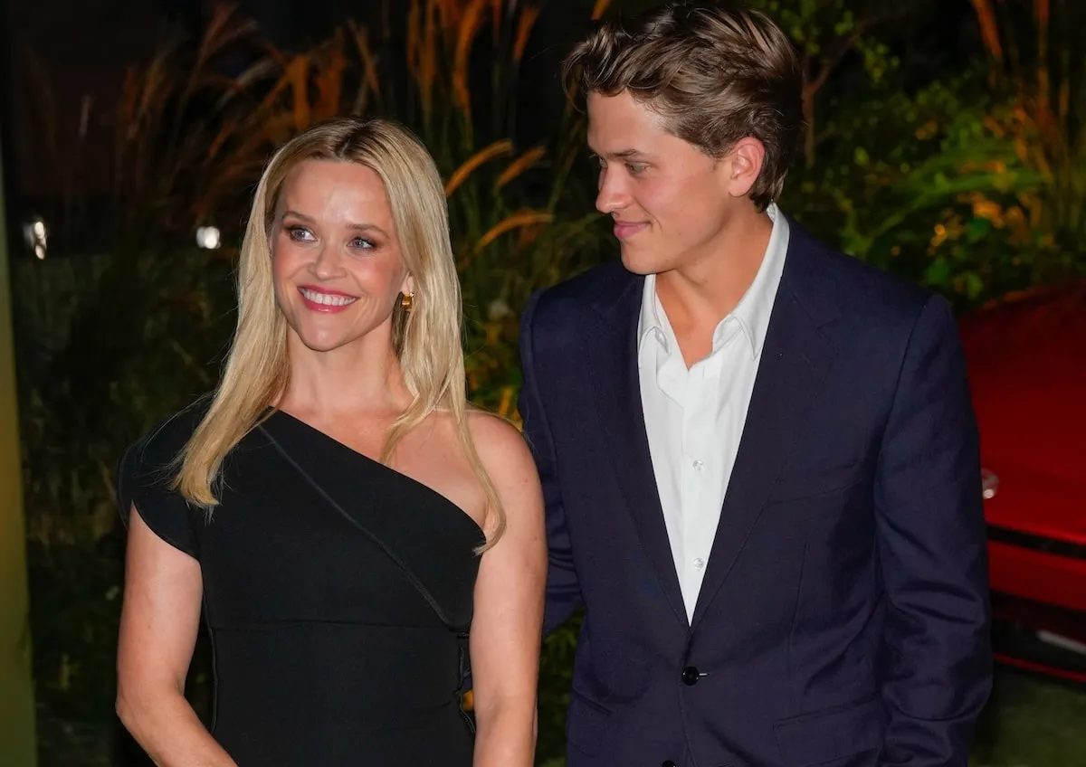 Deacon Phillippe stands next to his mom Reese Witherspoon as they smile on the green carpet at the WSJ Innovator Awards