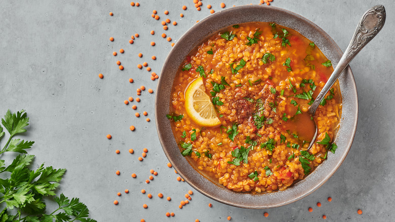 Bowl of Dal with herbs and lemon on top