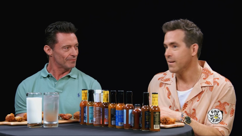 Deadpool & Wolverine stars Hugh Jackman and Ryan Reynolds test out a made-in-Montreal hot sauce during an episode of Hot Ones on YouTube. (Source: YouTube)