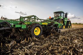 John Deere Coulter Chisel 21 pulled by a John Deere tractor.