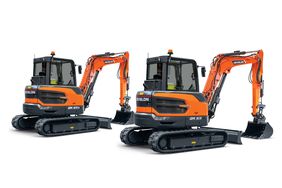 Two orange Develon mini excavators