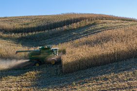 A John Deere combine harvests mature corn in hilly western Iowa in late October.