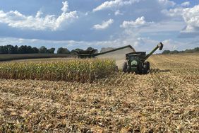 Corn harvest on a North Carolina farm with a John Deere combine and tractor