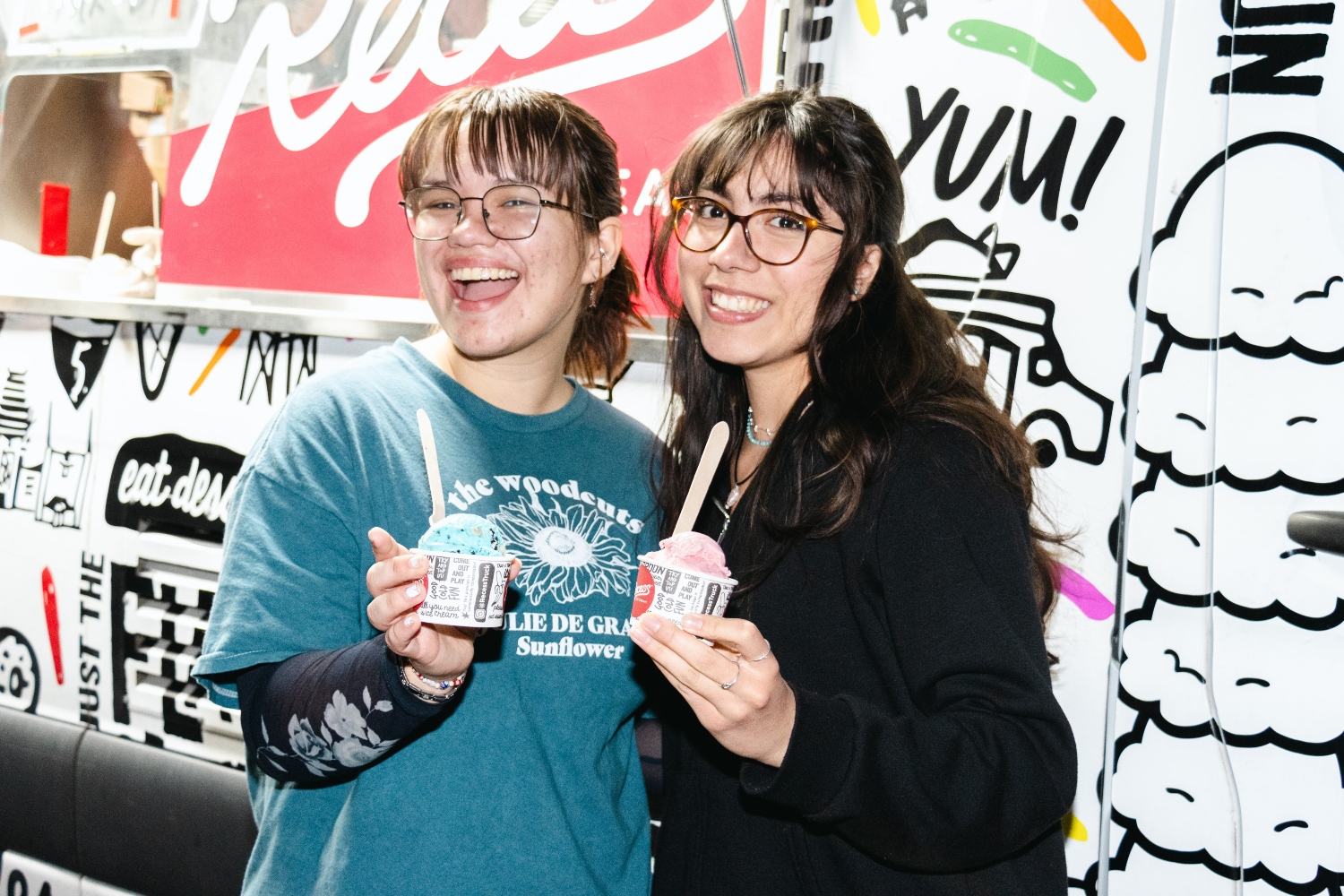 Students in front of ice cream truck smiling