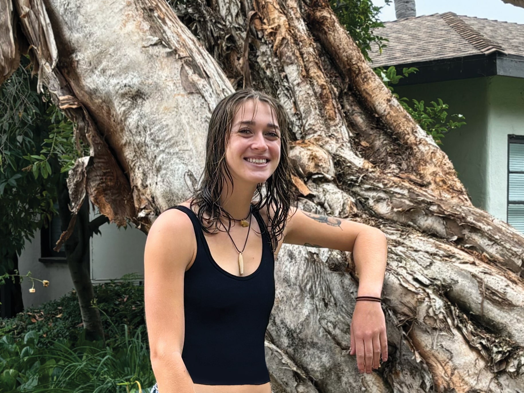 Kali Jo leans against a tree at APU